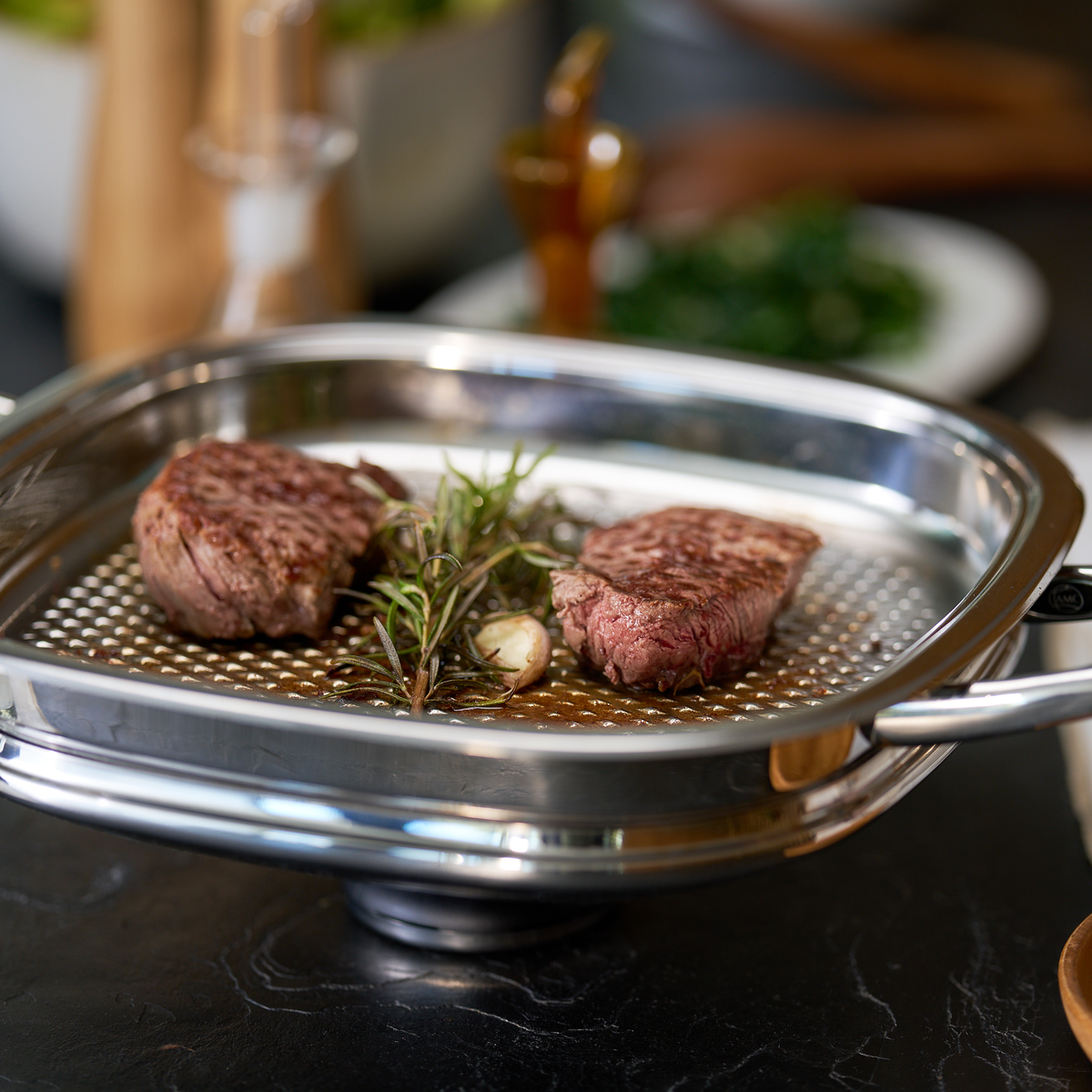 Steak grilling in an A by AMC grill pan