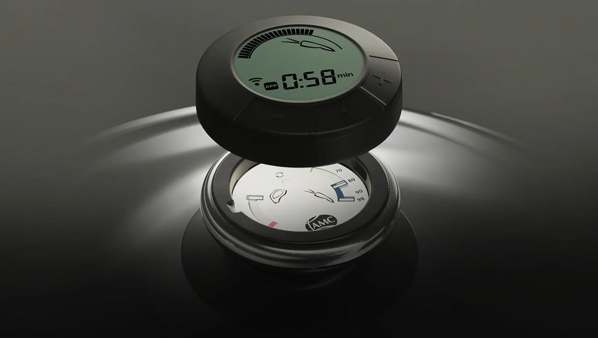 The Audiotherm lifted above a lid, showing its timer display over the lid temperature gauge