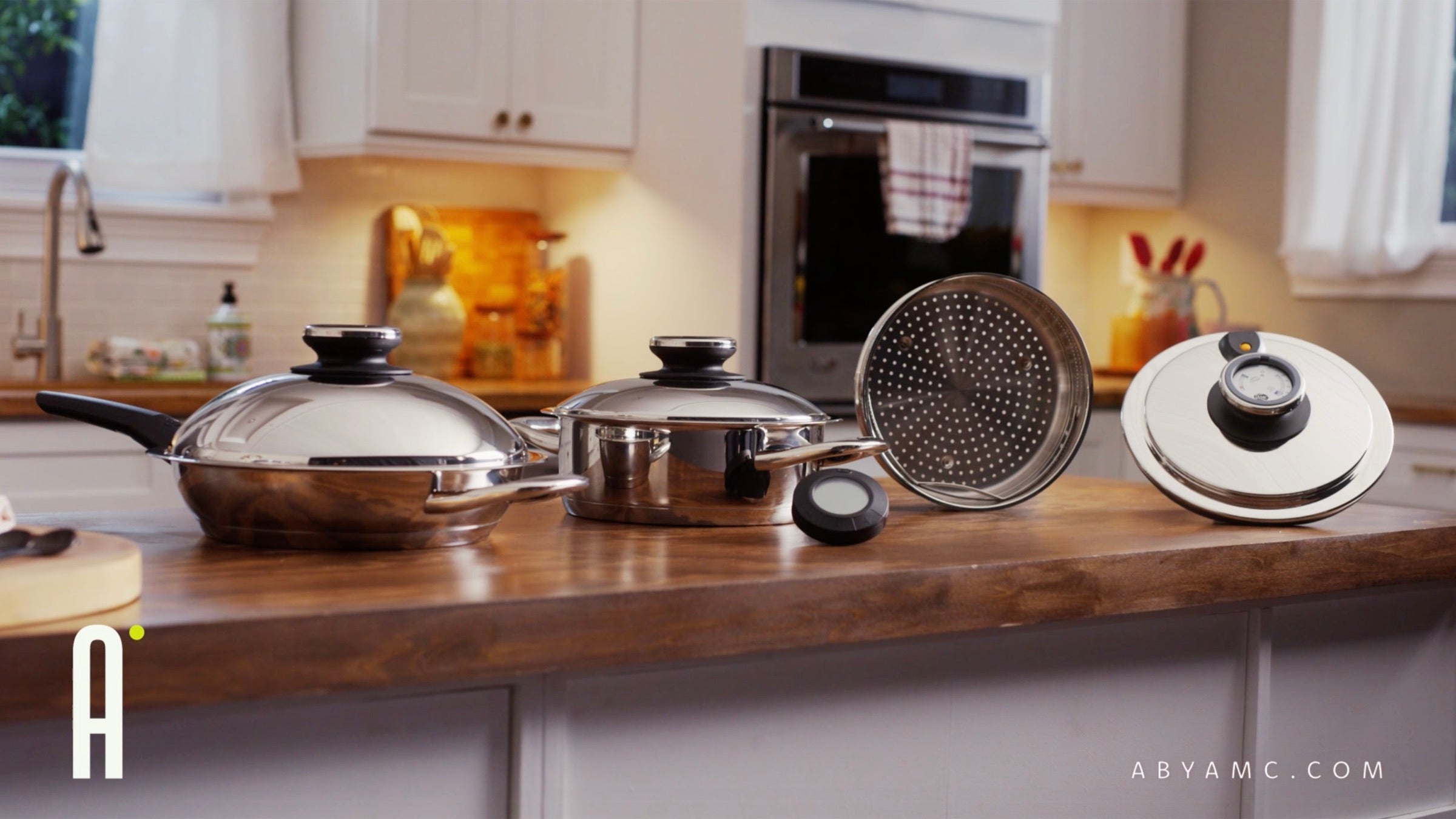 A by AMC stainless cookware on a kitchen countertop